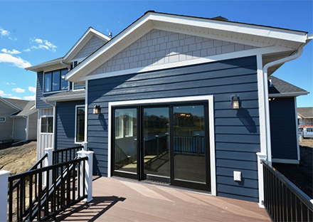 JAMES HARDIE LAP SIDING IN DEEP OCEAN WITH MARVIN WINDOWS & DOORS &TIMBERTECH DECKING